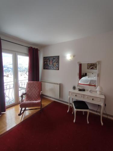 a bedroom with a desk and a mirror and a chair at Villa Kuna in Sarajevo
