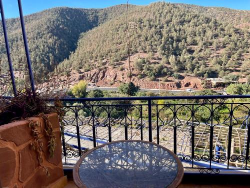 a table on a balcony with a view of a mountain at Kasbah Tifirte Grand Vallet in Ourika