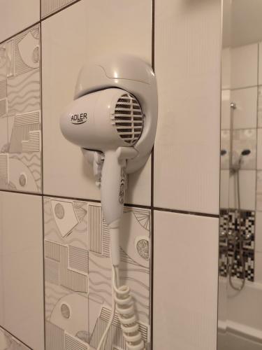 a hairdryer hanging on a wall in a bathroom at Villa Kuna in Sarajevo