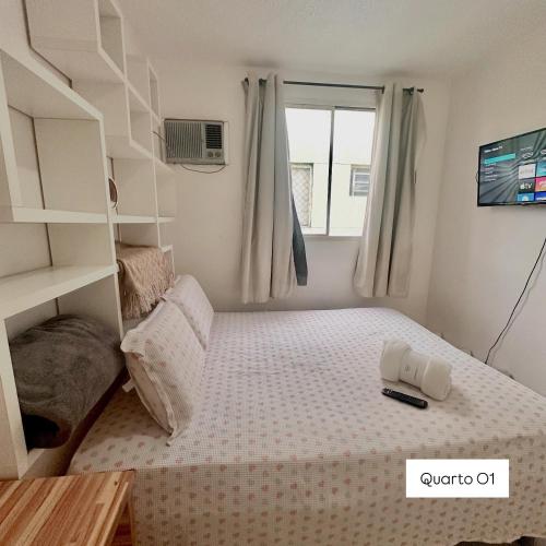 a small bedroom with a bed and a ladder at Apto 01 Alpinia Tarumã - Ehouse Manaus in Manaus