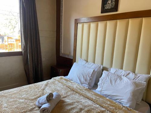 a bed with two rolled towels sitting on it at Kasbah Tifirte Grand Vallet in Ourika