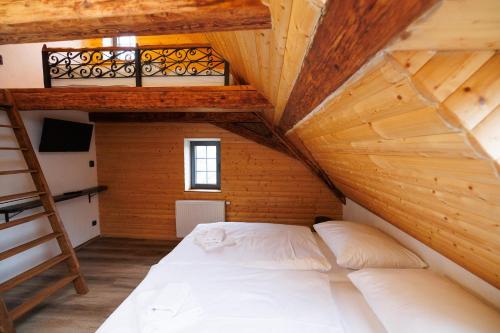 a bed in a room with a loft at Horní Strakův mlýn in Úštěk