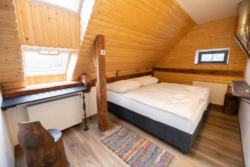a bedroom with a bed in a wooden cabin at Horní Strakův mlýn in Úštěk