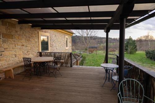 a wooden deck with a table and chairs on it at Horní Strakův mlýn in Úštěk