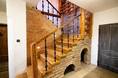 a staircase in a house with a brick wall at Horní Strakův mlýn in Úštěk