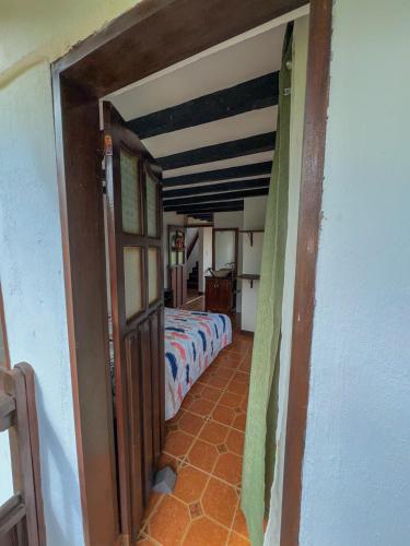 an open doorway to a bedroom with a bed at Hostal Pachamama in San Agustín