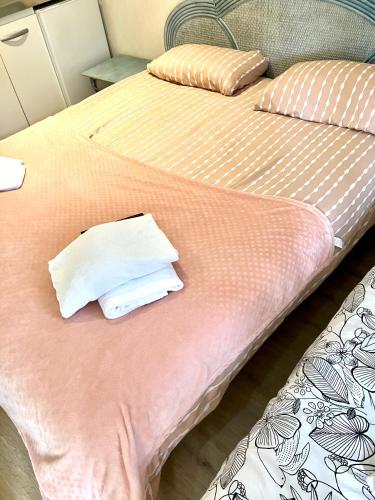 two beds sitting next to each other with towels on them at Résidence Normandie in Conches-en-Ouche