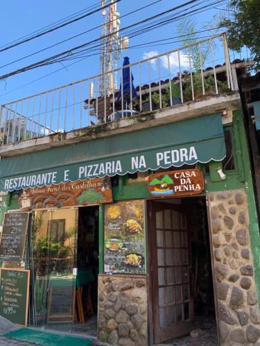 a restaurant with a sign on the side of a building at Pousada Casa da Penha in Abraão