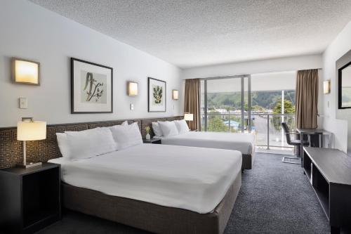 a hotel room with two beds and a balcony at Edit Picton in Picton