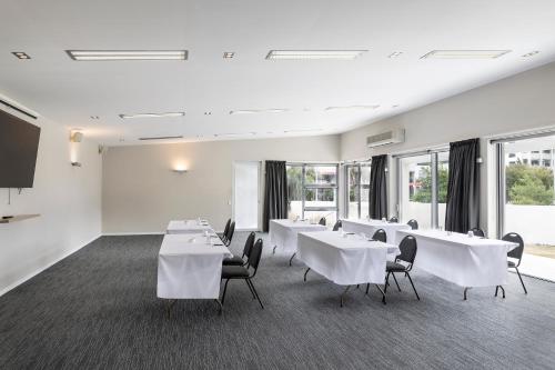a conference room with white tables and chairs at Edit Picton in Picton