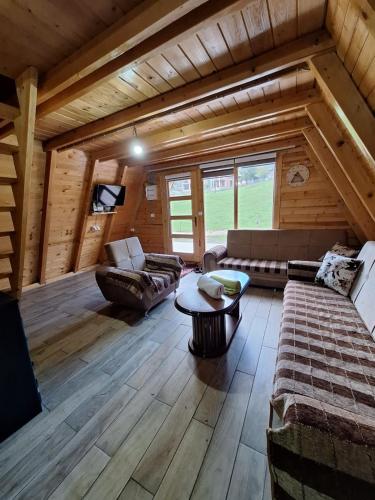 a living room with couches and a table in a cabin at Villa Alpina in Boge
