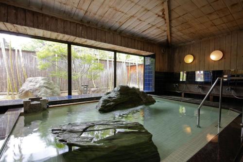 a large pool of water with rocks in it at Sekitaitei Ishida in Achi