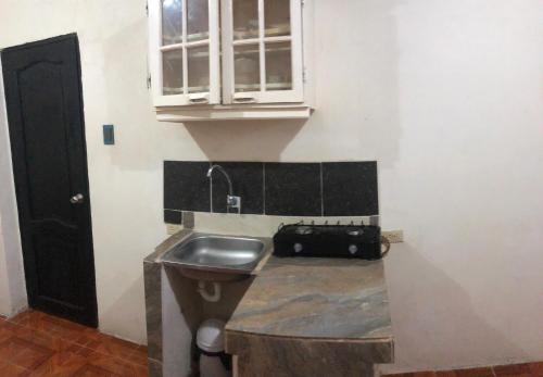 a kitchen with a sink and a cabinet at hospedaje Maluli suit 2 in Santa Elena