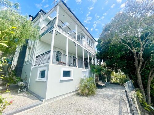 a large white building with a balcony on it at Blue Seas Villa in Napier