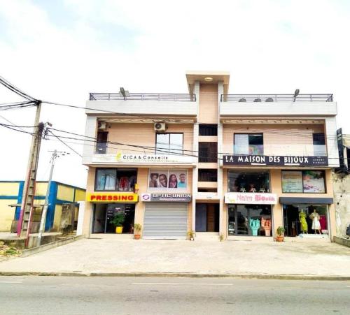 a building on the corner of a street at Résidence Ahydeney in Abidjan