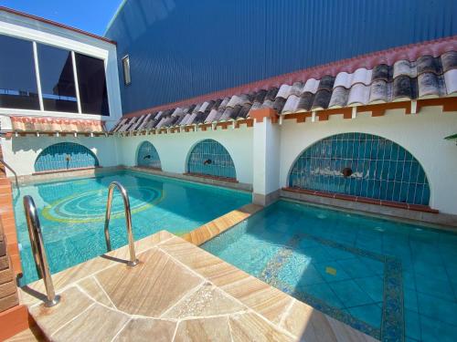 a swimming pool in a large building with a swimming pool at Ettalong Beach Tourist Resort in Ettalong Beach