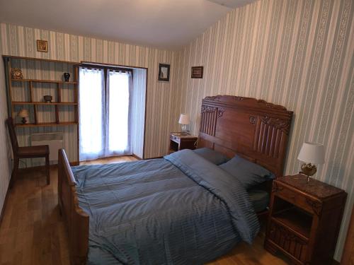 a bedroom with a large bed and a window at La rainette in Chaux