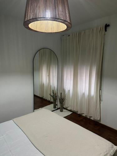 a bedroom with a bed and a large mirror at Carlis Home in Cordoba