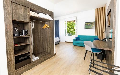 a living room with a blue couch and a table at Hotel Beaurivage in Noumea