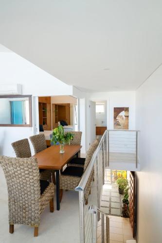 a dining room with a table and chairs at Azure Sea Whitsunday Resort in Airlie Beach