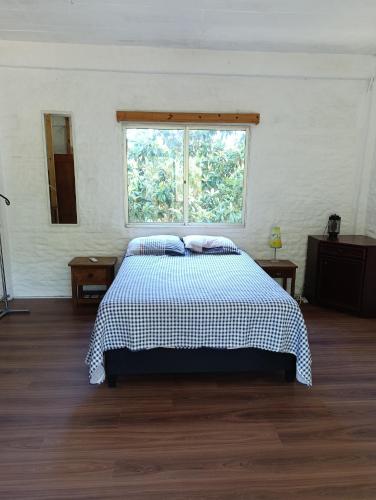 a bedroom with a large bed with a window at casa y monoambiente Britopolis in Fomento