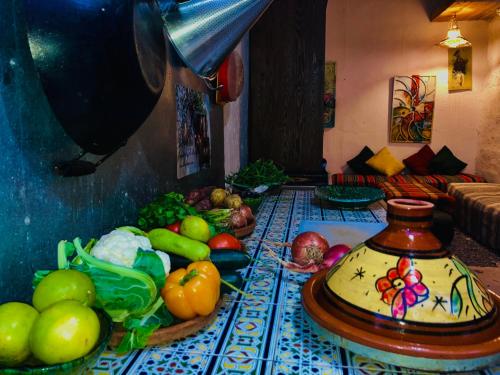 a table topped with lots of fruits and vegetables at Cozy 1BR Bungalow with Kitchen in Eco Garden Nature Escape in Agadir