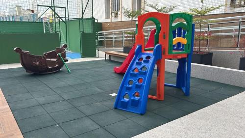 a playground with a slide and a swing at ER1208 - Apartamento aconchegante em São Luís in São Luís