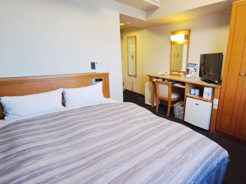 Postel nebo postele na pokoji v ubytování Hotel Route-Inn Mooka