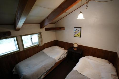 Ένα ή περισσότερα κρεβάτια σε δωμάτιο στο ありえすか alyeska