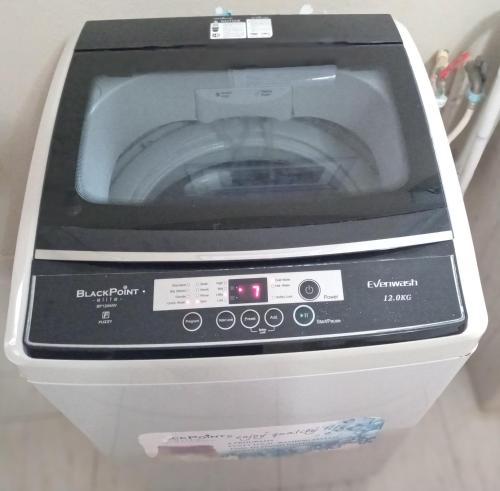 a washing machine is sitting in a room at Cozy Locale Pearl in Port Antonio