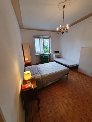 a large bedroom with a bed and a window at B&B del centro in Pinerolo