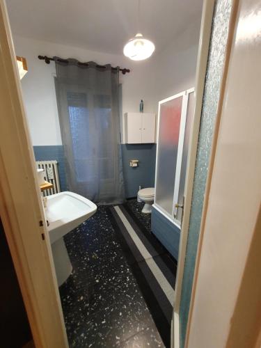 a bathroom with a sink and a toilet at B&B del centro in Pinerolo