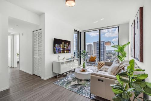 a living room with a couch and a large window at Experience Miami Modern 2 Bed Near Biscayne Blvd in Miami