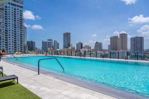 a large swimming pool on the roof of a building at Experience Miami Modern 2 Bed Near Biscayne Blvd in Miami