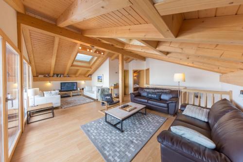 a living room with a couch and a table at Chalet Nid Blanc in Nendaz