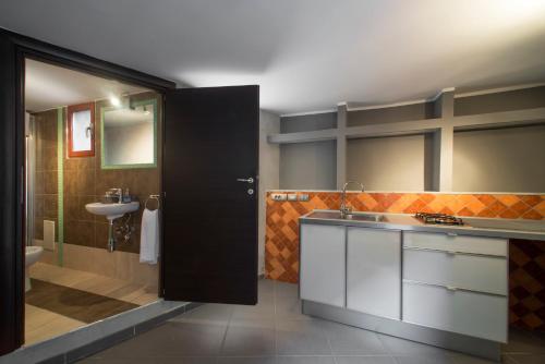 a bathroom with a sink and a toilet at Il Taschino Suite in Naples