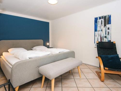 two beds in a room with a couch and a chair at 2 person holiday home in Højer in Højer