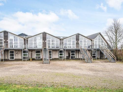 an exterior view of a large building with stairs at 2 person holiday home in Højer in Højer