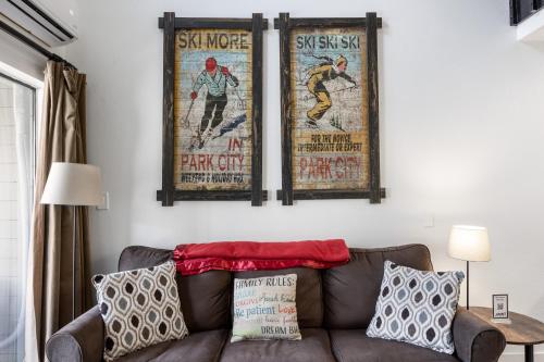 three posters hanging on a wall above a couch at Walk to Main Street and Ski Lifts, Amazing Views, Community Hot Tub! in Park City