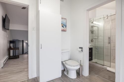 a white bathroom with a toilet and a shower at Walk to Main Street and Ski Lifts, Amazing Views, Community Hot Tub! in Park City