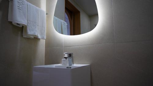 a bathroom with a white sink and a mirror at H avenue Songjeong in Busan