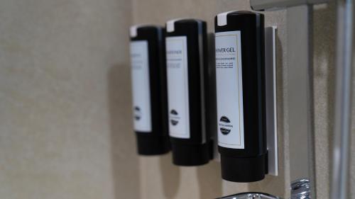a row of black and white devices on a wall at H avenue Songjeong in Busan