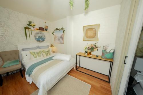 a bedroom with a bed and a table and a chair at Beach Serenity Guesthouse in Sydney