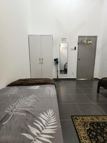 a hospital room with a bed and a mirror at Homestay faleeq in Jerantut