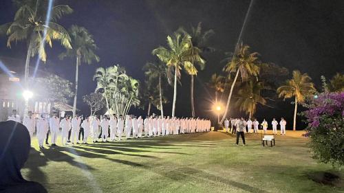 a group of men in white uniforms standing in a field at Taverno Villa in Serang