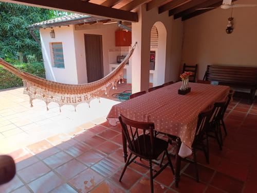a dining room with a table and chairs on a patio at Casa entera con jardín en Luque! in San Lorenzo