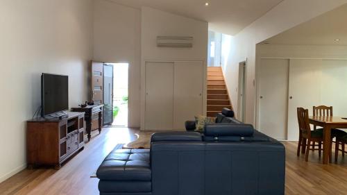a living room with a couch and a table at Hook Wine Sinker in Brunswick Heads