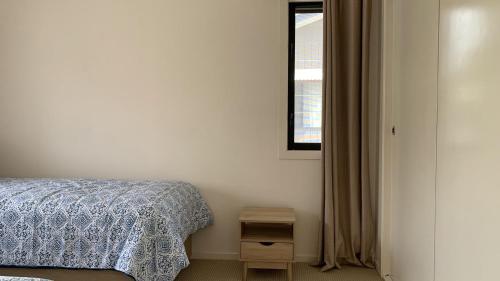 a bedroom with a bed and a window at Hook Wine Sinker in Brunswick Heads