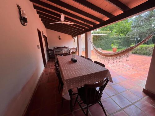 a dining room with a table and chairs on a patio at Casa entera con jardín en Luque! in San Lorenzo