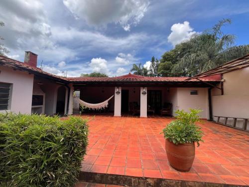 a house with a red brick patio with plants at Casa entera con jardín en Luque! in San Lorenzo